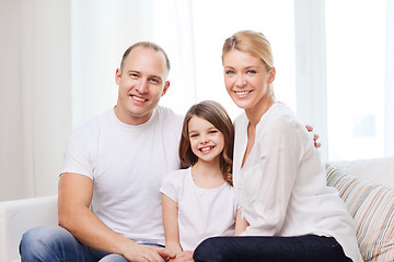 Image showing smiling parents and little girl at home