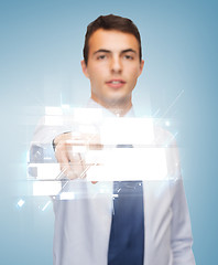 Image showing buisnessman pointing finger to virtual screen