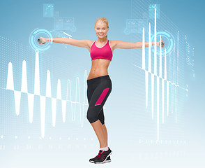 Image showing young sporty woman with light dumbbells