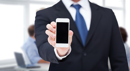 Image showing businessman showing smartphone with blank screen