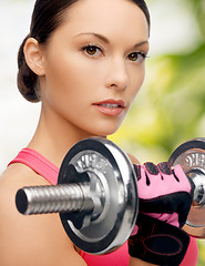 Image showing asian sporty woman with heavy dumbbell