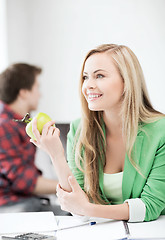 Image showing student girl with green apple in college