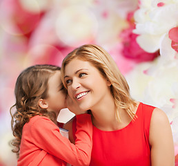 Image showing smiling mother and daughter whispering gossip