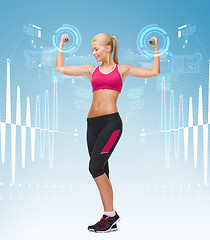 Image showing young sporty woman with light dumbbells