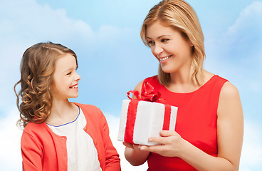 Image showing smiling mother and daughter with gift box
