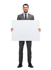 Image showing smiling businessman with white blank board