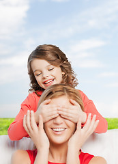 Image showing smiling mother and daughter making a joke
