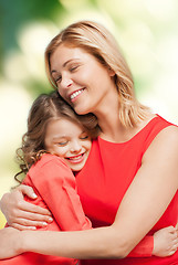 Image showing smiling mother and daughter hugging