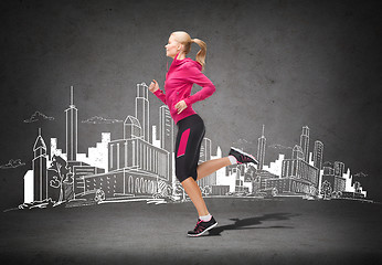 Image showing sporty woman running or jumping