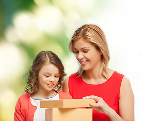 Image showing smiling mother and daughter opening gift box