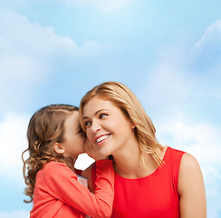 Image showing smiling mother and daughter whispering gossip