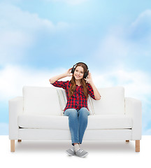 Image showing teenage girl sitting on sofa with headphones