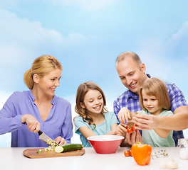 Image showing happy family with two kids making dinner at home