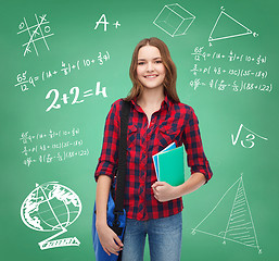 Image showing smiling female student with bag and notebooks