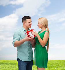 Image showing smiling couple with gift box