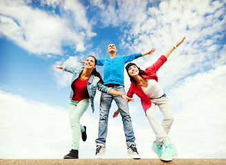 Image showing group of teenagers spreading hands