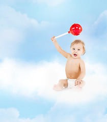 Image showing cute little boy playing with big lollipop