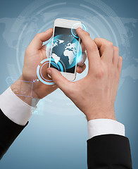 Image showing businessman touching screen of smartphone