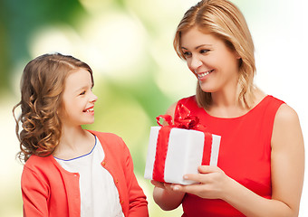 Image showing smiling mother and daughter with gift box