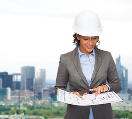 Image showing businesswoman in white helmet with blueprint