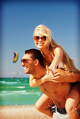 Image showing happy couple in sunglasses on the beach