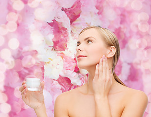 Image showing woman applying cream on her skin