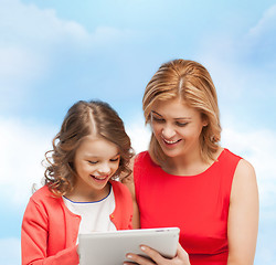 Image showing smiling mother and daughter with tablet pc