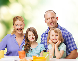 Image showing happy family with two kids with having breakfast