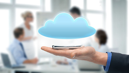 Image showing hand holding smartphone with cloud