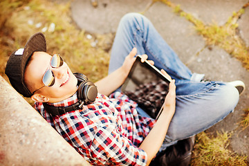 Image showing girl with headphones and tablet pc