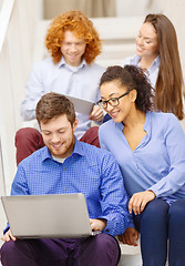 Image showing team with laptop and tablet pc on staircase