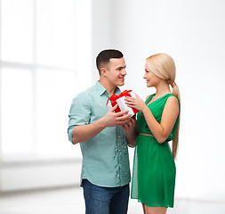 Image showing smiling couple with gift box