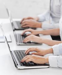 Image showing group of people working with laptops in office