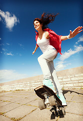 Image showing teenage girl skating outside