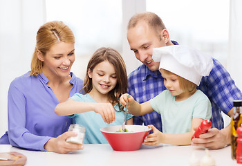 Image showing happy family with two kids eating at home