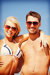 Image showing happy couple in sunglasses on the beach