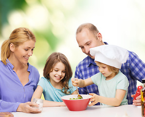 Image showing happy family with two kids eating at home