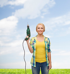 Image showing smiling woman with drill machine