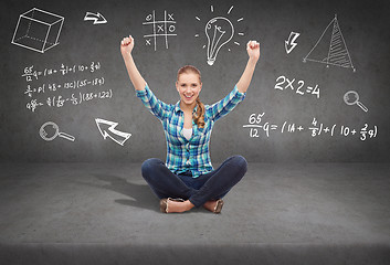 Image showing young woman in casual clothes sitting on floor