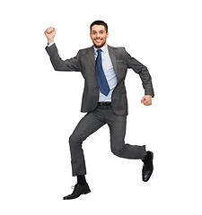 Image showing smiling businessman jumping