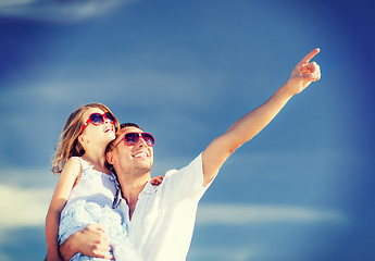 Image showing happy father and child in sunglasses over blue sky