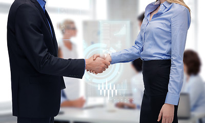 Image showing man and woman shaking their hands in office