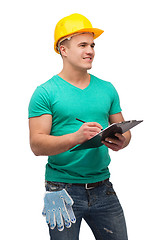 Image showing smiling man in helmet with clipboard