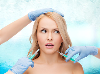 Image showing woman face and beautician hands with syringes