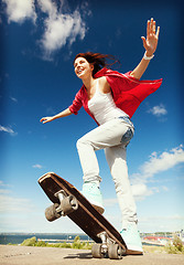 Image showing teenage girl skating outside