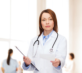 Image showing calm female doctor with clipboard