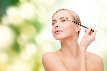 Image showing beautiful woman with makeup brush