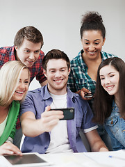 Image showing students looking into smartphone at school