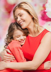 Image showing smiling mother and daughter hugging