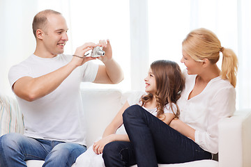 Image showing happy father taking picture of mother and daughter